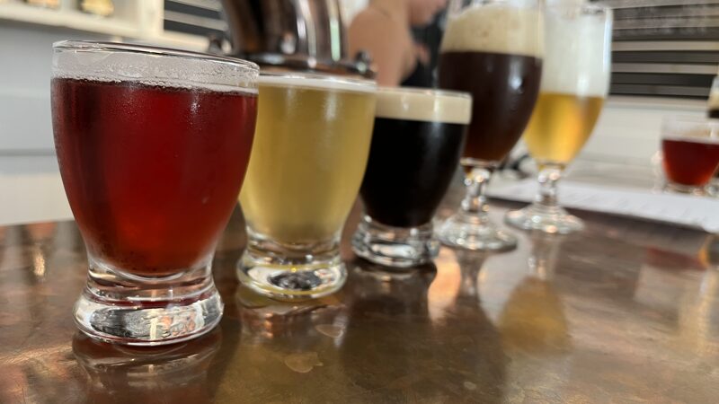 Checked in: Niagara Oast House Brewers - Craft Brewery in Niagara On The Lake Five small glasses of beer on a copper bar top