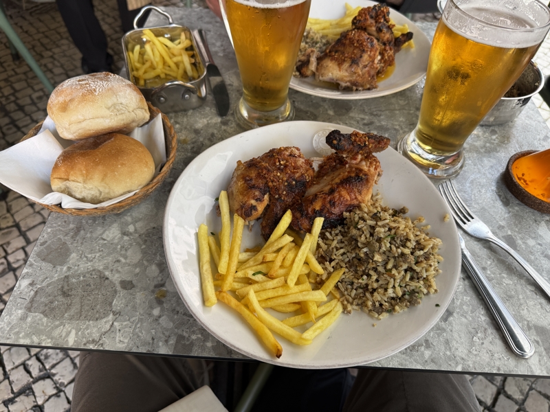 Checked in: Bonjardim A plate of peri-peri chicken, rice, fries and a beer on an outdoor table