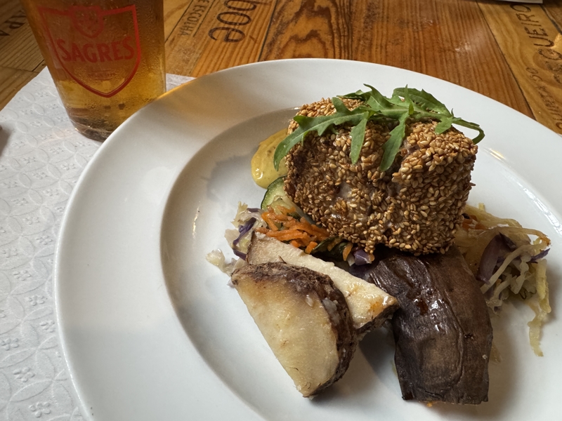 Checked in: A Tasca A sesame encrusted tuna steak sits atop a bed of vegetables on a white plate with a pint glass of beer on the side