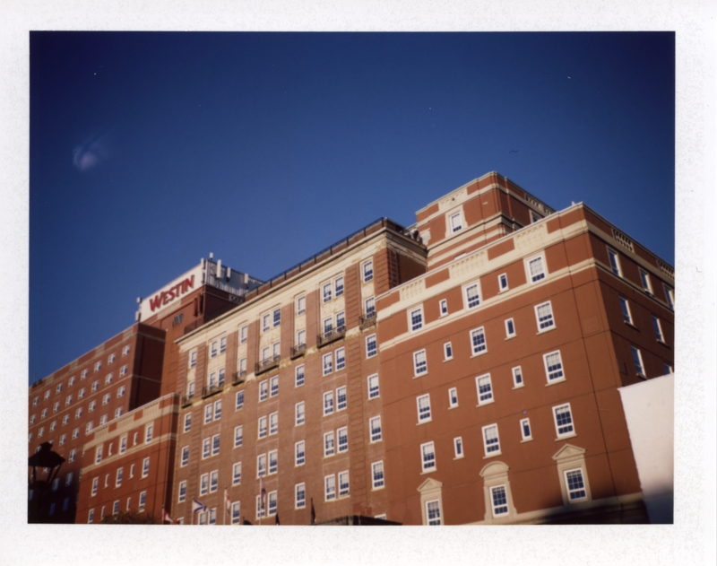 The Nova Scotian, October, 2024 A large red brick hotel is pictured against a bright blue sky with a sign reading Westin in red on the front